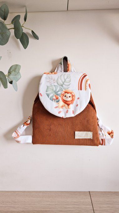Cartable velours lion arc en ciel marron en stock 